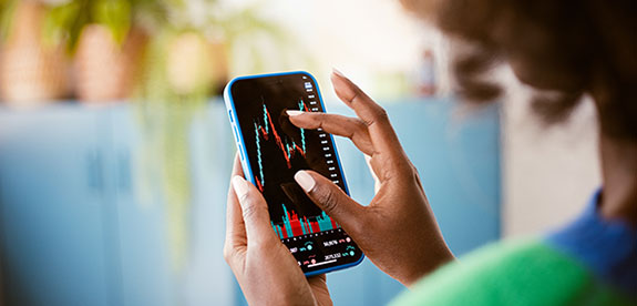 A woman reviewing her cash balance online with a mobile phone