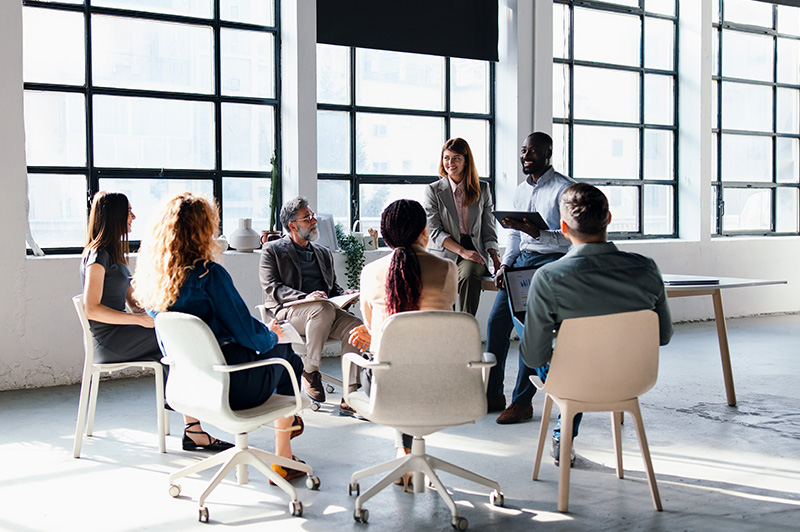 A group of employees sit in for a meeting