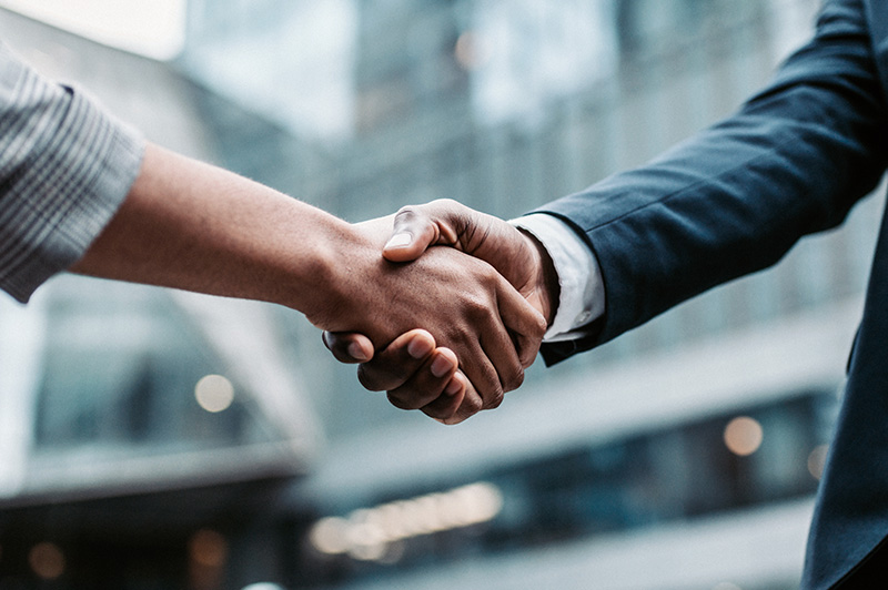 Two people shake hands