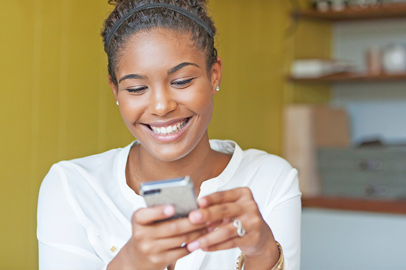 Happy woman looking at her phone