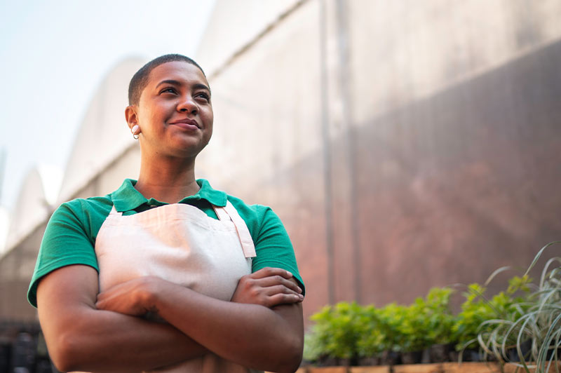 Smiling plant nursery business owner