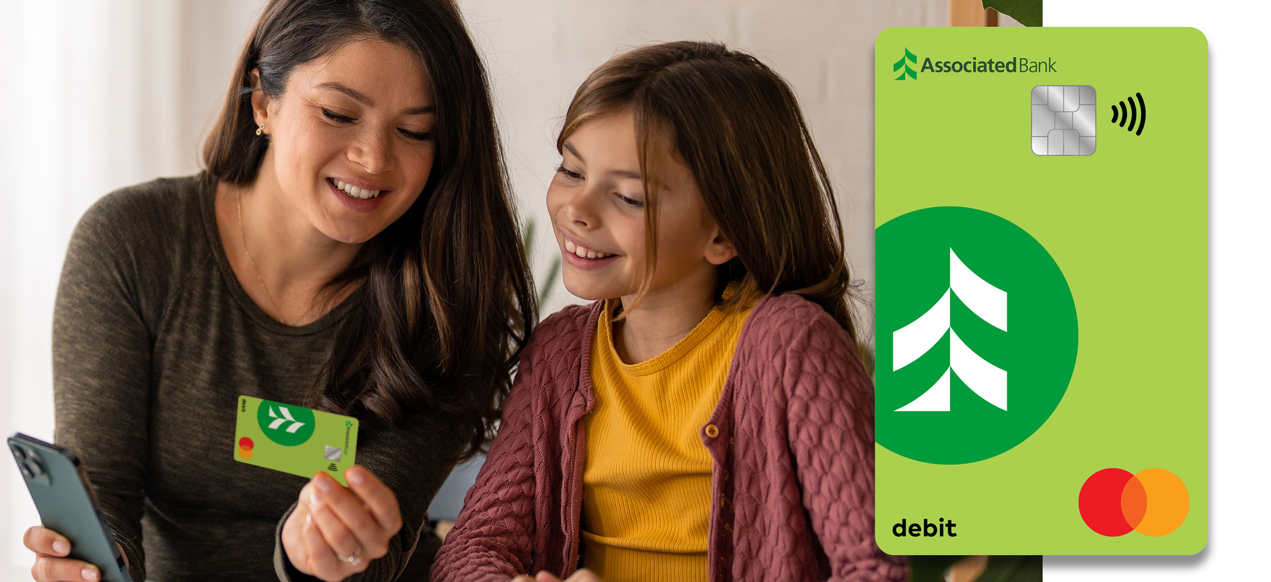 A mother and daughter reviewing a debit card together.