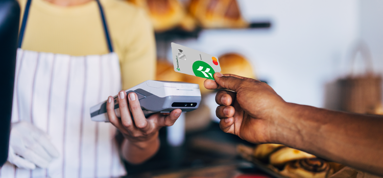 A credit card is used to make a purchase at a bakery